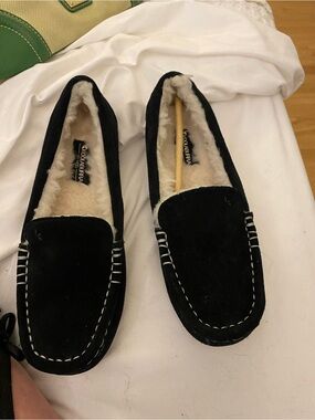 Ugg brand black suede slip ons with faux fur lining